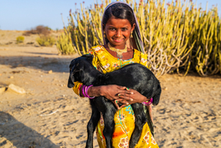 Girl holding a black sheep